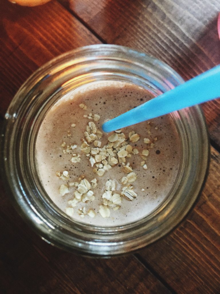 Banana + almond milk + 1/2 packet chocolate protein powder + stevia + ice + 1/4 CUP OATS