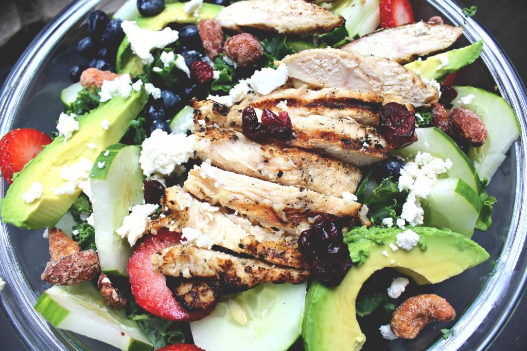 Balsamic Kale Salad W/Berries, Grilled Chicken, Honey Roasted Mixed Nuts, Avocado, Goat Cheese, Dried Cranberries and Cucumber!