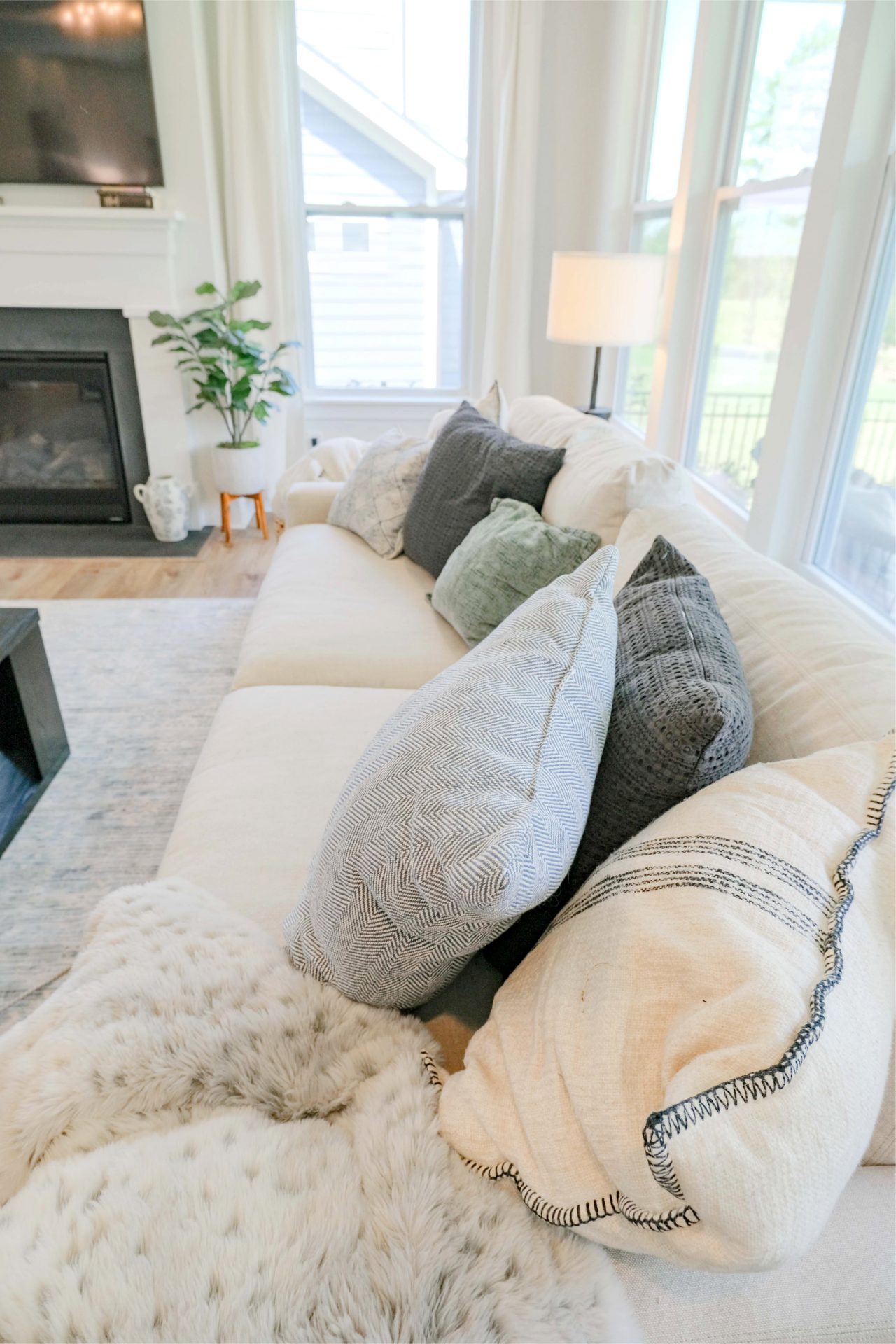 living room tour, target throw pillows, blue, black, arhaus, Remington sofas, my home, fielding homes, aura, plank cottage, white, board and button, home, outside, interior, fort mill, south Carolina, white kitchen, masons bend