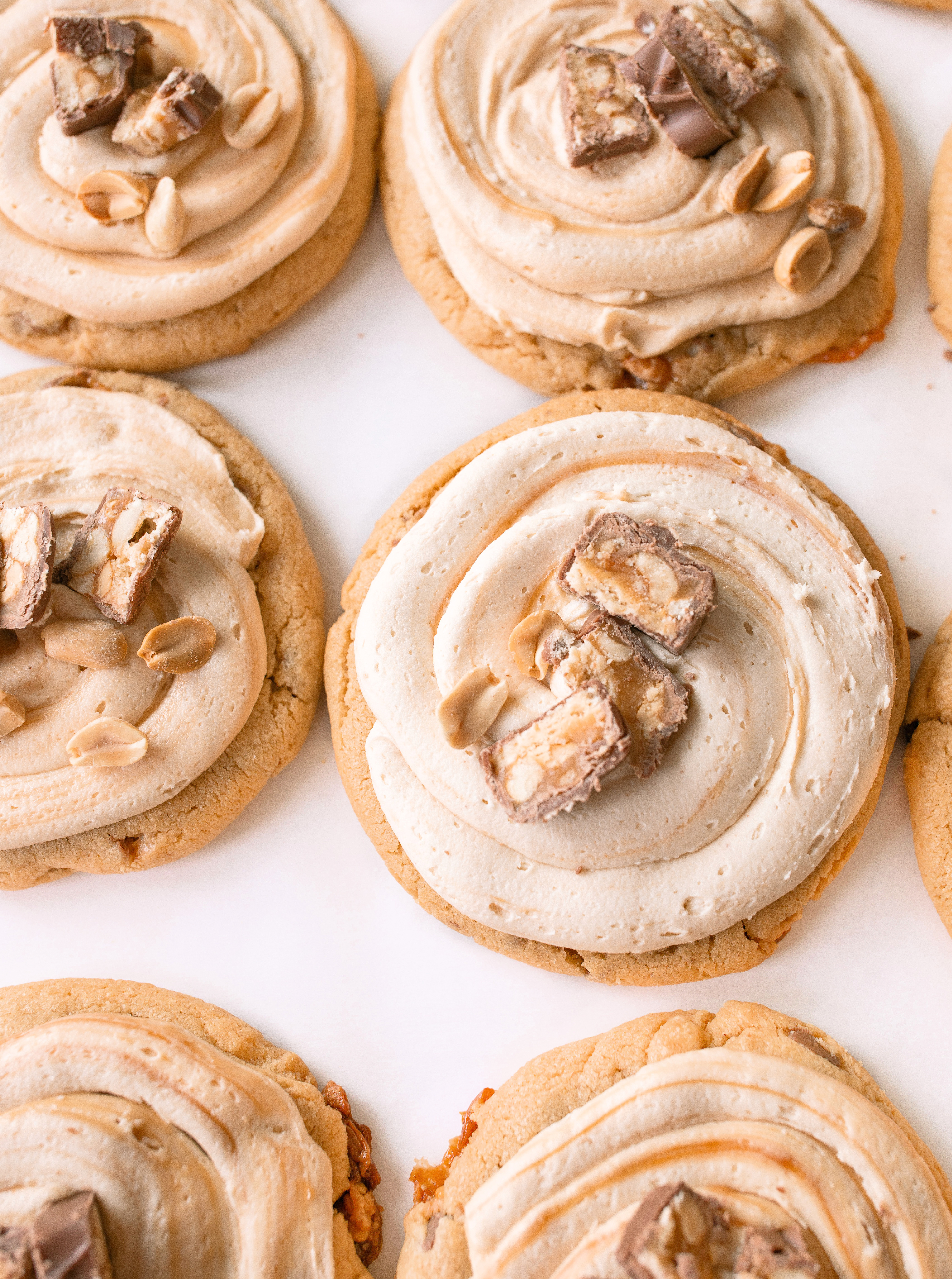 frosted cookies, snickers, dessert, candy bar, homemade salted caramel buttercream, buttercream frosting, peanut butter snickers cookies, peanut butter cookies, amazing dessert ever, the best frosted cookie recipe, salted caramel buttercream, peanut butter cookies, baking, soft, thick cookies, bakery, recipe