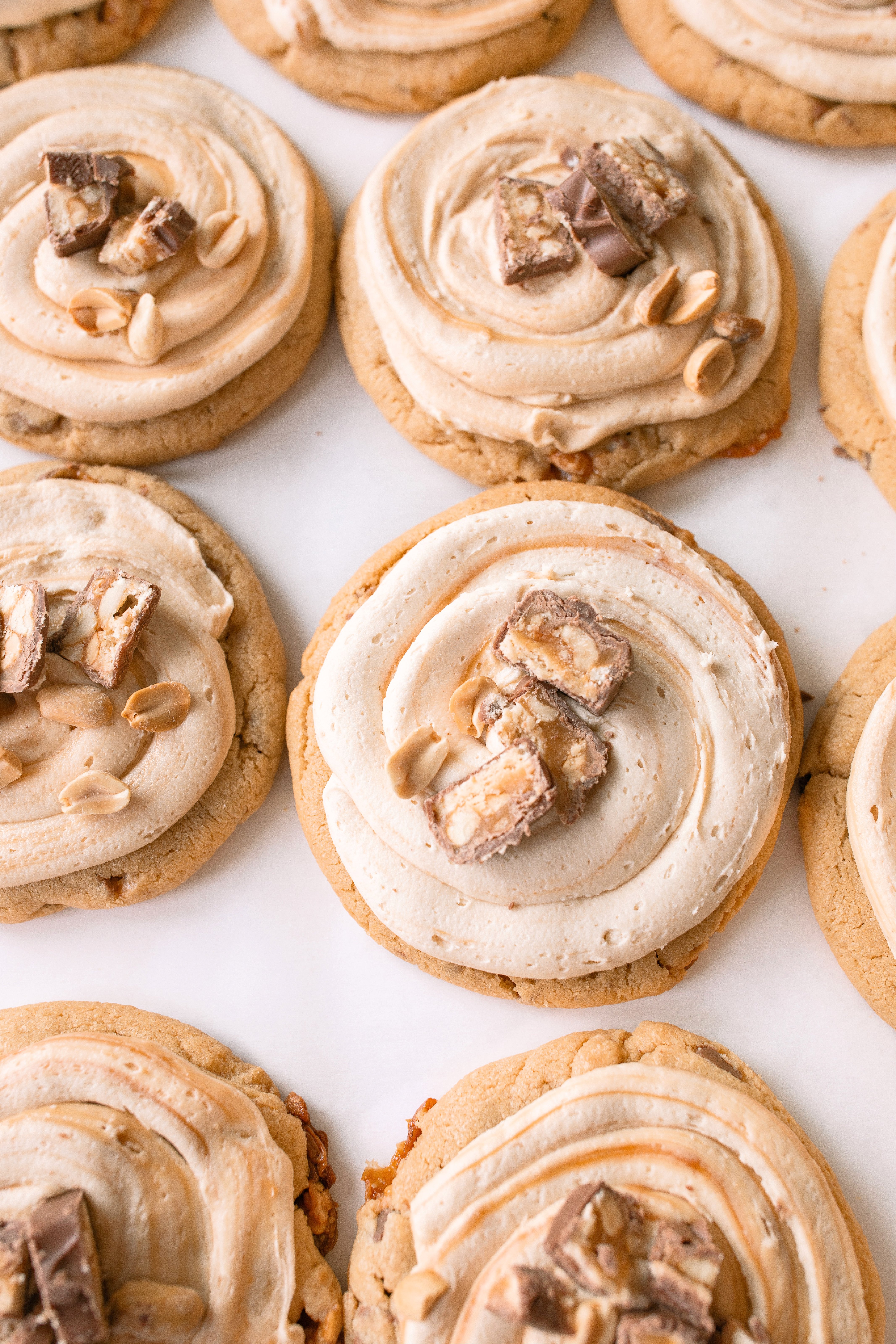 frosted cookies, snickers, dessert, candy bar, homemade salted caramel buttercream, buttercream frosting, peanut butter snickers cookies, peanut butter cookies, amazing dessert ever, the best frosted cookie recipe, salted caramel buttercream, peanut butter cookies, baking, soft, thick cookies, bakery, recipe