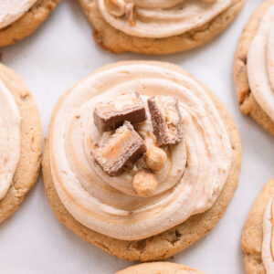 frosted cookies, snickers, dessert, candy bar, homemade salted caramel buttercream, buttercream frosting, peanut butter snickers cookies, peanut butter cookies, amazing dessert ever, the best frosted cookie recipe, salted caramel buttercream, peanut butter cookies, baking, soft, thick cookies, bakery, recipe