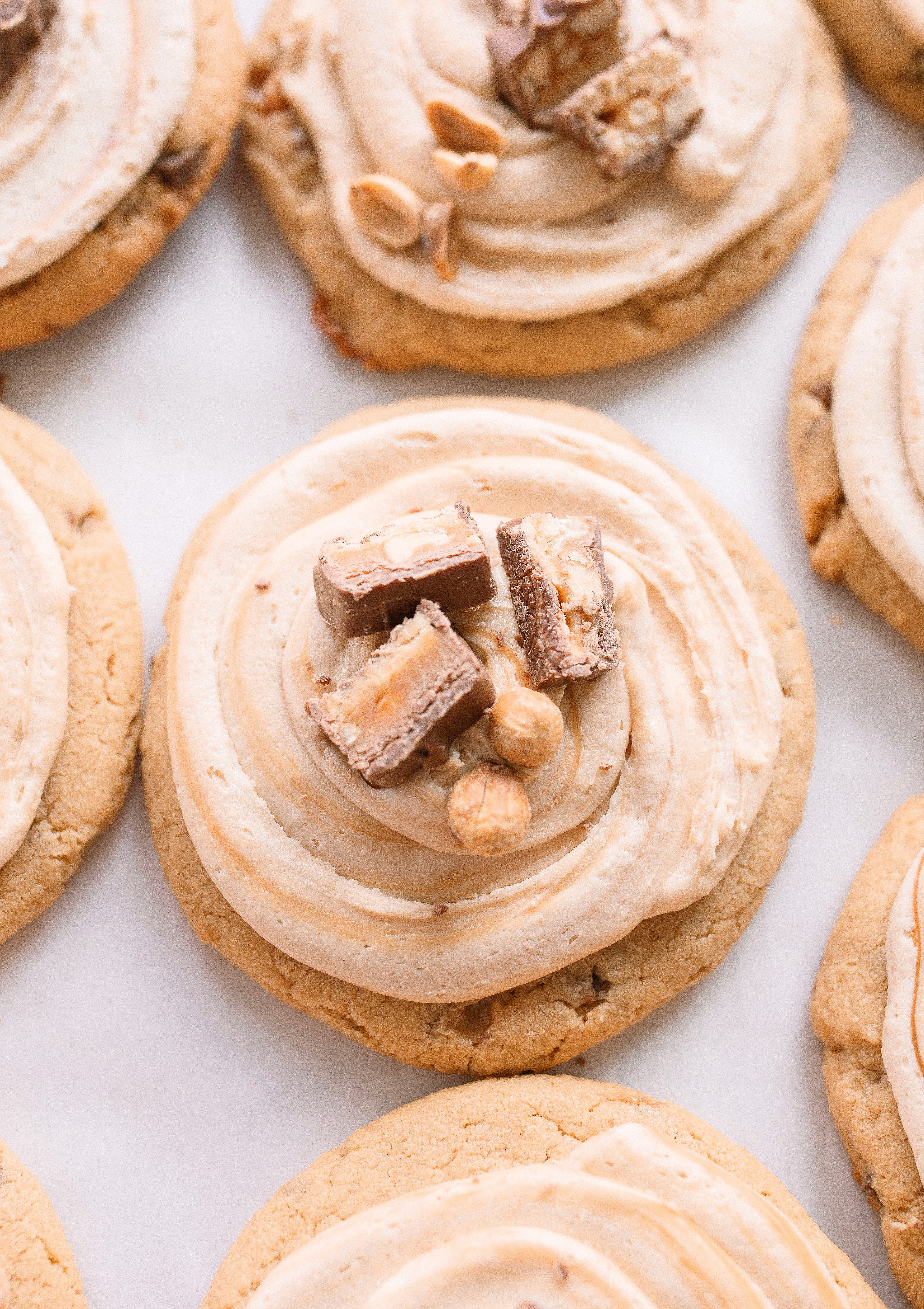 frosted cookies, snickers, dessert, candy bar, homemade salted caramel buttercream, buttercream frosting, peanut butter snickers cookies, peanut butter cookies, amazing dessert ever, the best frosted cookie recipe, salted caramel buttercream, peanut butter cookies, baking, soft, thick cookies, bakery, recipe