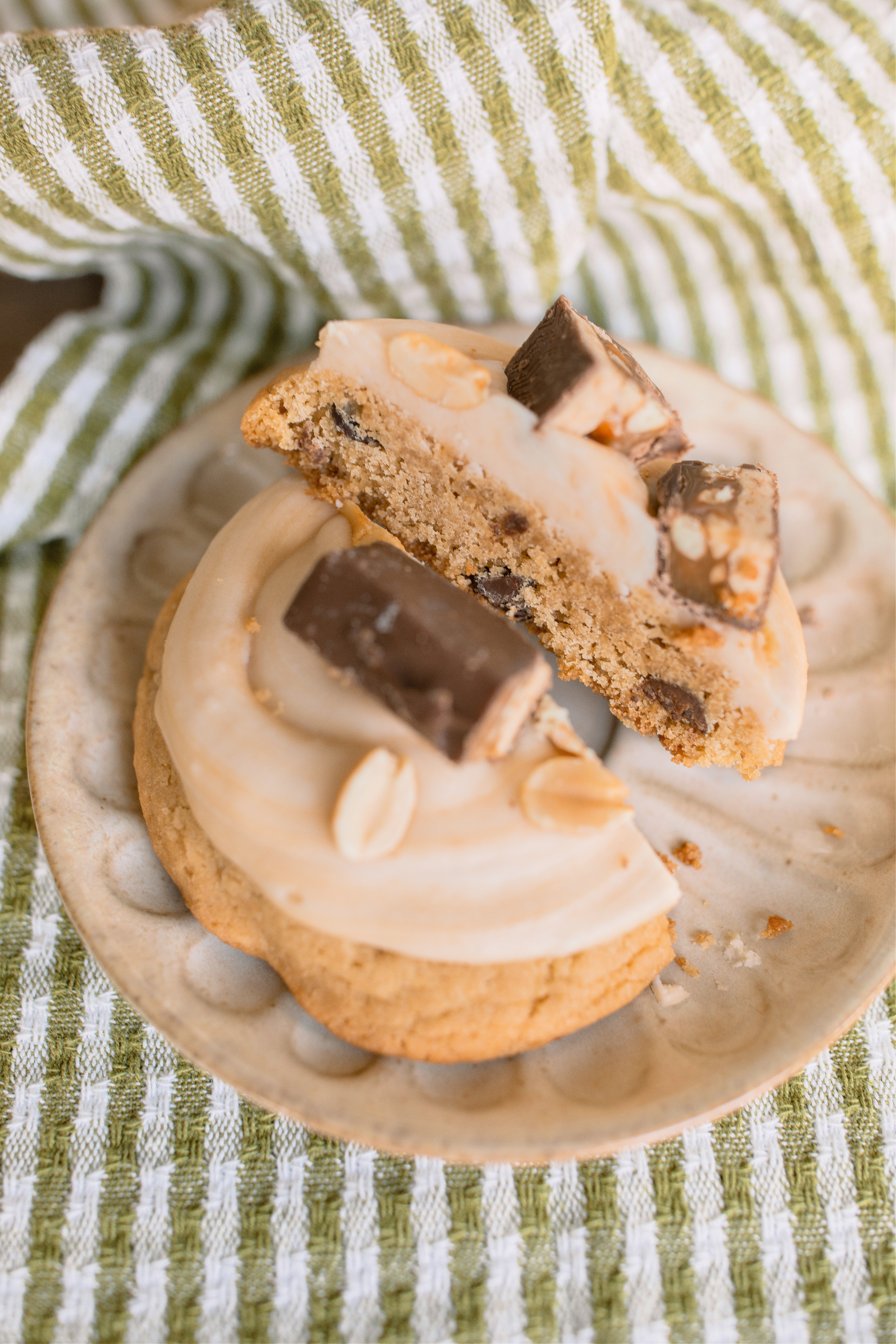 frosted cookies, snickers, dessert, candy bar, homemade salted caramel buttercream, buttercream frosting, peanut butter snickers cookies, peanut butter cookies, amazing dessert ever, the best frosted cookie recipe, salted caramel buttercream, peanut butter cookies, baking, soft, thick cookies, bakery, recipe