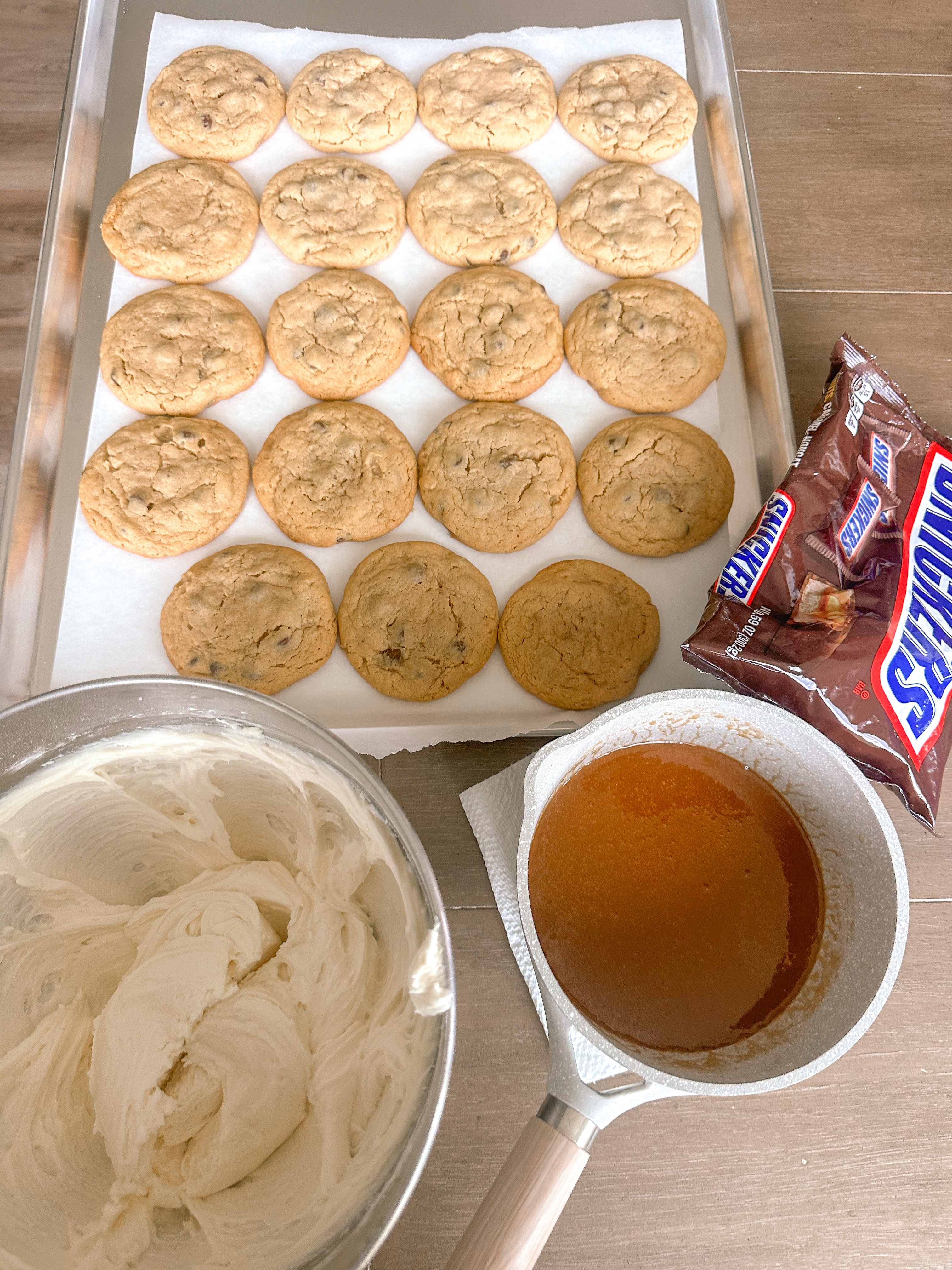 frosted cookies, snickers, dessert, candy bar, homemade salted caramel buttercream, buttercream frosting, peanut butter snickers cookies, peanut butter cookies, amazing dessert ever, the best frosted cookie recipe, salted caramel buttercream, peanut butter cookies, baking, soft, thick cookies, bakery, recipe