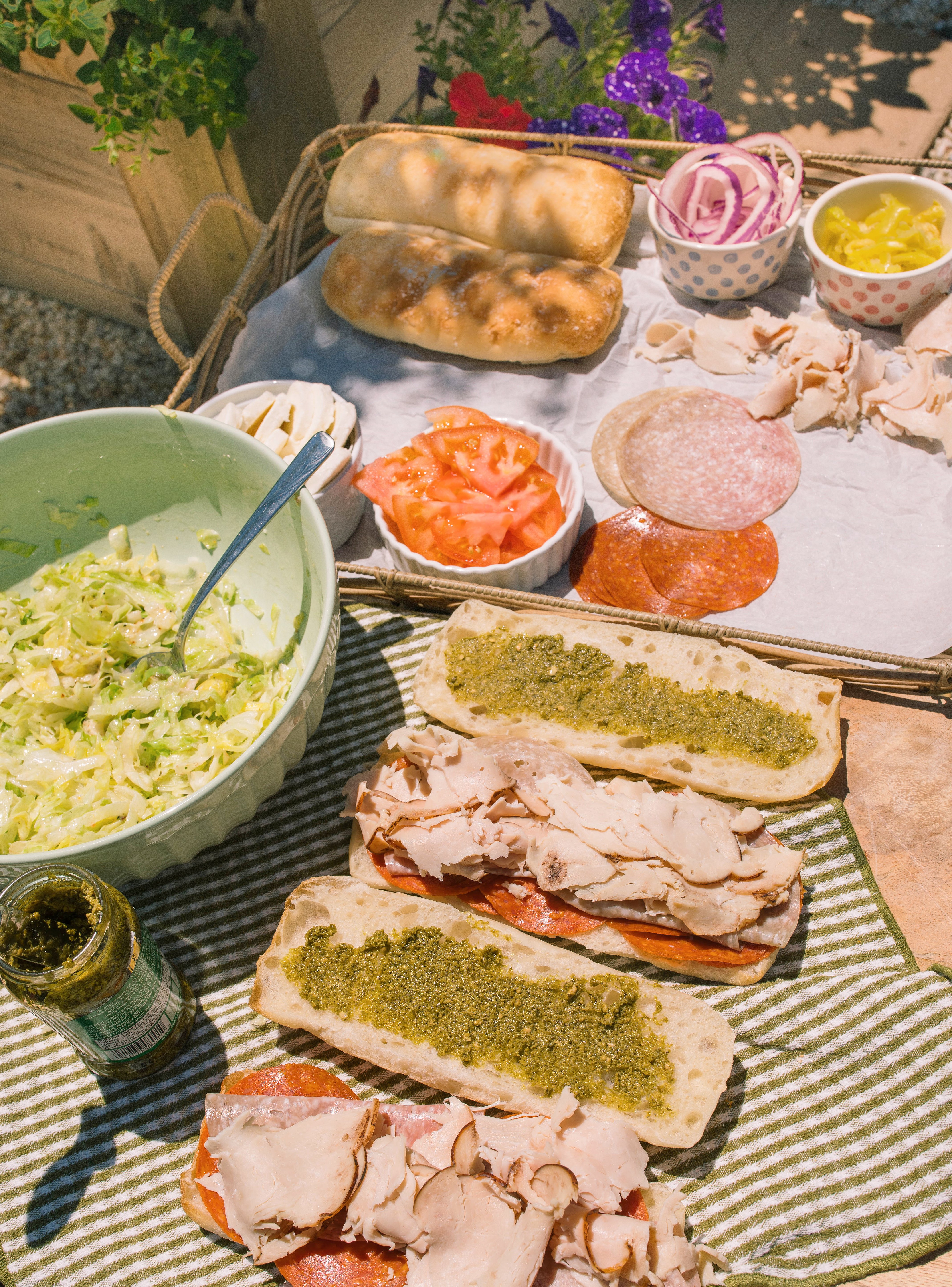Italian subs, Italian sub recipe, homemade Italian subs, pool day sandwiches, summer sandwich recipes, easy Italian sandwich, toasted Italian subs, deli style subs, Italian hoagie recipe, summer lunch ideas, crowd pleasing sandwiches, family lunch recipes, sandwich recipes for a crowd, mozzarella Italian sandwich, pesto Italian subs, homemade Italian dressing, picnic sandwich ideas, beach sandwiches, pool party food ideas, easy summer meals, Italian grinder sandwich, grinder sandwich recipe, layered Italian sandwich, cold sandwich recipes, hot Italian sandwich, salami sandwich recipe, turkey and salami sandwich, fresh mozzarella sandwich, banana pepper sandwich, bakery bread sandwiches, easy entertaining recipes, lunch sandwich ideas, make ahead sandwiches, summer entertaining food, Italian deli sandwich, crispy lettuce sandwich, oven baked subs, easy pool day food, family friendly sandwiches