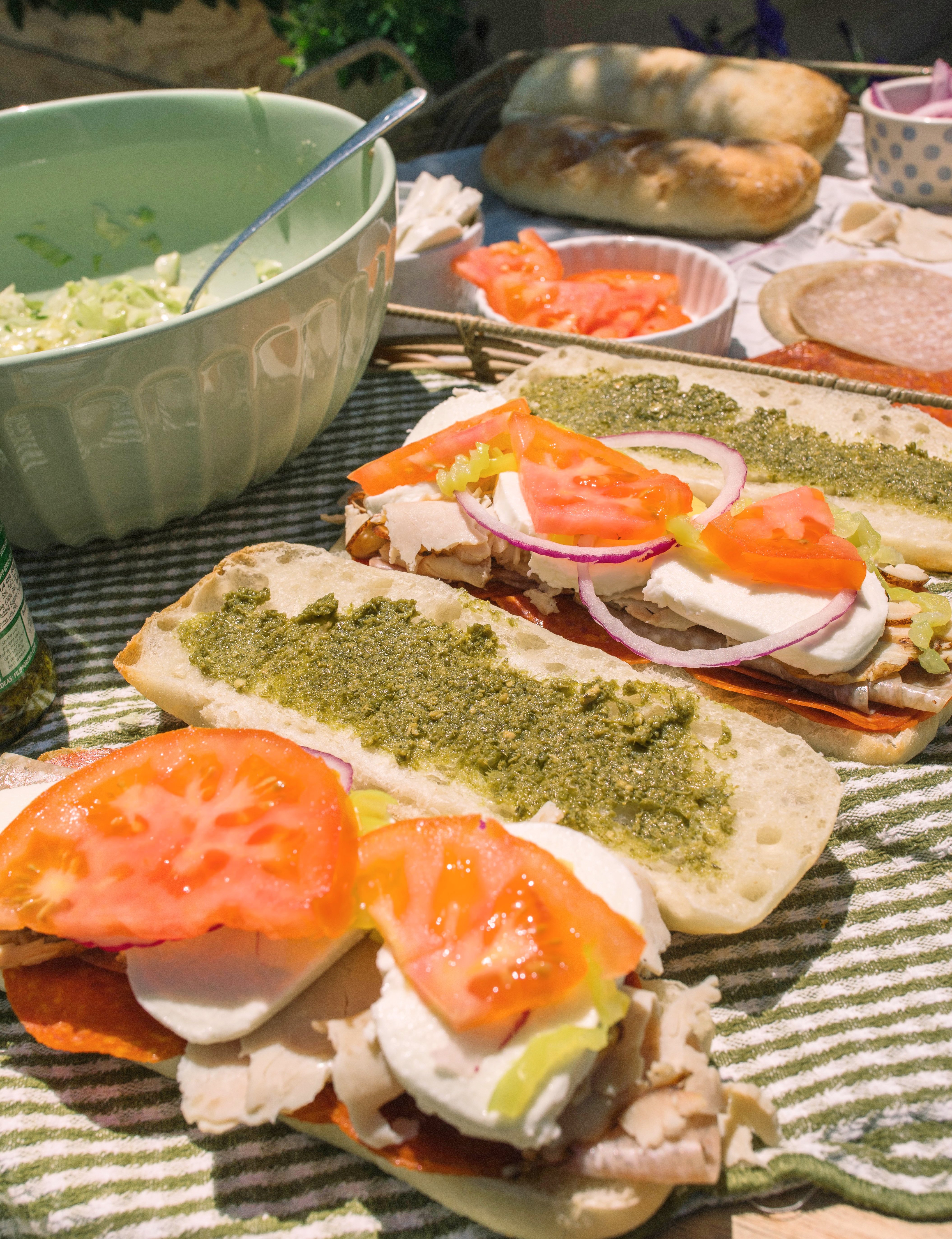 Italian subs, Italian sub recipe, homemade Italian subs, pool day sandwiches, summer sandwich recipes, easy Italian sandwich, toasted Italian subs, deli style subs, Italian hoagie recipe, summer lunch ideas, crowd pleasing sandwiches, family lunch recipes, sandwich recipes for a crowd, mozzarella Italian sandwich, pesto Italian subs, homemade Italian dressing, picnic sandwich ideas, beach sandwiches, pool party food ideas, easy summer meals, Italian grinder sandwich, grinder sandwich recipe, layered Italian sandwich, cold sandwich recipes, hot Italian sandwich, salami sandwich recipe, turkey and salami sandwich, fresh mozzarella sandwich, banana pepper sandwich, bakery bread sandwiches, easy entertaining recipes, lunch sandwich ideas, make ahead sandwiches, summer entertaining food, Italian deli sandwich, crispy lettuce sandwich, oven baked subs, easy pool day food, family friendly sandwiches