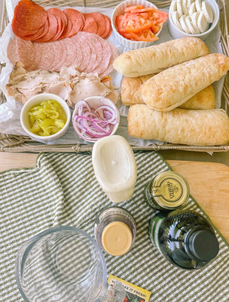Italian subs, Italian sub recipe, homemade Italian subs, pool day sandwiches, summer sandwich recipes, easy Italian sandwich, toasted Italian subs, deli style subs, Italian hoagie recipe, summer lunch ideas, crowd pleasing sandwiches, family lunch recipes, sandwich recipes for a crowd, mozzarella Italian sandwich, pesto Italian subs, homemade Italian dressing, picnic sandwich ideas, beach sandwiches, pool party food ideas, easy summer meals, Italian grinder sandwich, grinder sandwich recipe, layered Italian sandwich, cold sandwich recipes, hot Italian sandwich, salami sandwich recipe, turkey and salami sandwich, fresh mozzarella sandwich, banana pepper sandwich, bakery bread sandwiches, easy entertaining recipes, lunch sandwich ideas, make ahead sandwiches, summer entertaining food, Italian deli sandwich, crispy lettuce sandwich, oven baked subs, easy pool day food, family friendly sandwiches